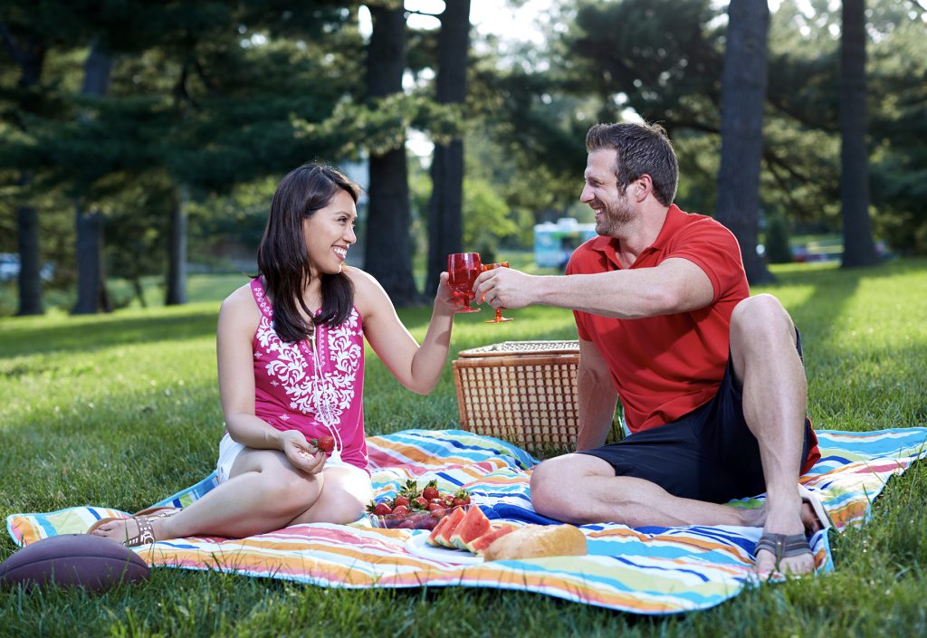 family eating at a picnic smiling in nice clothes